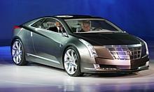 General Motors Vice Chairman Bob Lutz (left) arrives in the Cadillac Converj electric luxury coupe concept - making its world debut - at the North American International Auto Show in Detroit.